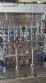 Complete filling line with Tecman Nelpas Tecnoenvase Tudela bottle filling, labeling, capping, and positioning machines for cosmetic liquids.