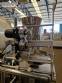 Vertical wrapping machine for triangular format