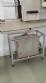 Label applicator machine with steam-operated shrink tunnel for sleeves.