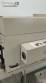Label applicator machine with steam-operated shrink tunnel for sleeves.