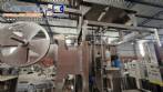 Labeling machine with steam sleeve tunnel and bottle baler