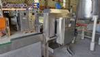 Labeling machine with steam sleeve tunnel and bottle baler