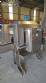 Labeling machine with steam sleeve tunnel and bottle baler