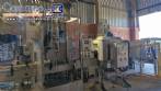 Labeling machine with steam sleeve tunnel and bottle baler