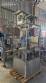 Labeling machine with steam sleeve tunnel and bottle baler