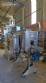 Labeling machine with steam sleeve tunnel and bottle baler