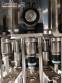 Zegla rotary filling machine with rinser and three-block capping system.