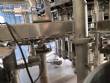 Zegla rotary filling machine with rinser and three-block capping system.