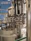 Zegla rotary filling machine with rinser and three-block capping system.